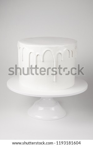 Simple white cake with glaze on a white background. Picture for a menu or a confectionery catalog.