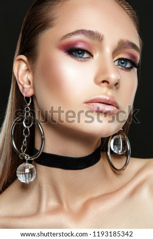 Beautiful woman portrait with glamour make up and big earrings.