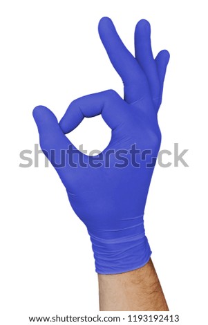 Male hand in blue medical glove showing approval ok sign isolated on white background