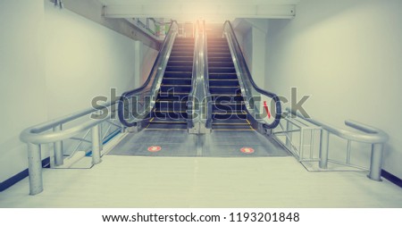 Escalator in business office building. Moving up staircase. . electric escalator. yellow bands. metal line steel. yellow gray steel line.