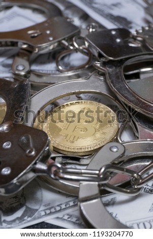 Bitcoin surrounded with handcuffs. Conceptual photography of financial fraud