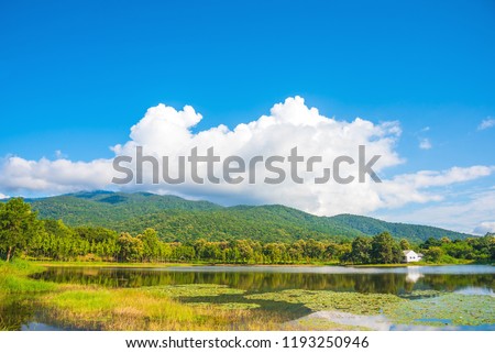 image of house near the lake and the mountain with beautiful blue sky in morning time.