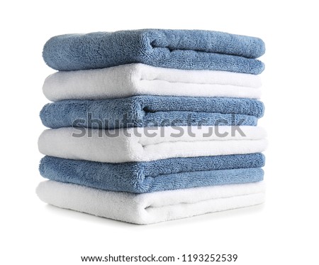 Stack of clean soft towels on white background Royalty-Free Stock Photo #1193252539