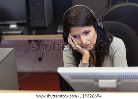 Bored woman in computer room in college