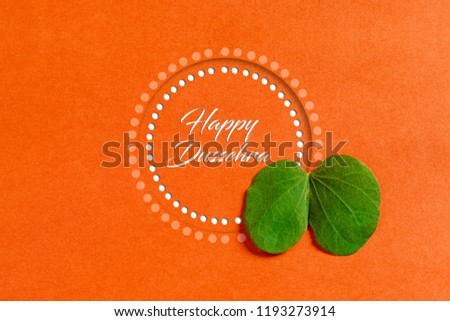 Happy Dussehra greeting card , green leaf and rice Royalty-Free Stock Photo #1193273914