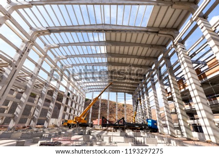 View of the interior of the new construction of the industrial building and cranes. Construction as an industry comprises six to nine percent of the gross domestic product of developed countries.