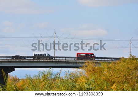 This picture shows two buses going on a bridge over the river Selenga of Ulan-Ude city