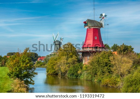 Famous twin windmills at the village of Greetsiel, German North Sea region Royalty-Free Stock Photo #1193319472