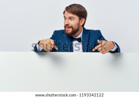 a man in a suit behind a white drawing paper mockup, poster                               