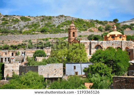 Panoramic view of the Colonial church of Cerro de San Pedro, the stone houses and part of the mine on the background in San Luis Potosí, Mexico. 