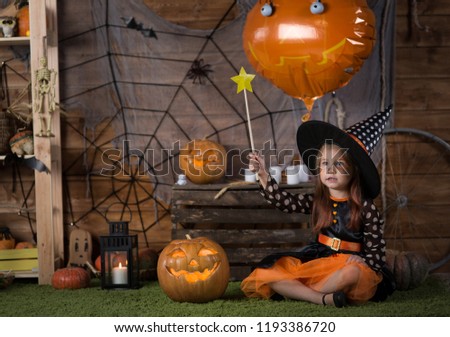Baby girl in a witch costume for Halloween 