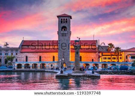 Rhodes, Greece. Stunning sunset image Mandraki harbour and Evaggelismos Church the place of Colossus of Rhodes. Royalty-Free Stock Photo #1193397748