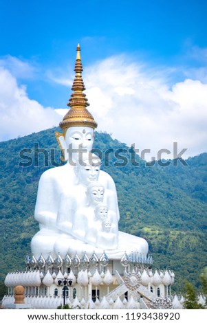Blurred white buddha statue on sky blue or azure sky and cloud on daytime. Wat Pha Son Kaew temple is famous temple for travel in Thailand 