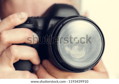 photographer with camera in hand