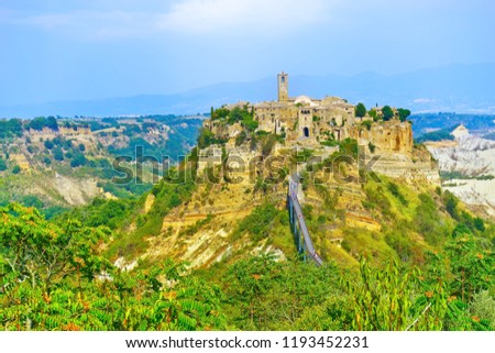 View of Civita village located on a hill and connected with Bagnoregio town by a bridge in central Italy.
