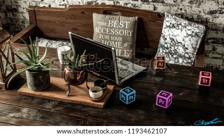 Vintage kitchen table with, laptop, coffee mug, pillows, plants and adobe cubes Royalty-Free Stock Photo #1193462107