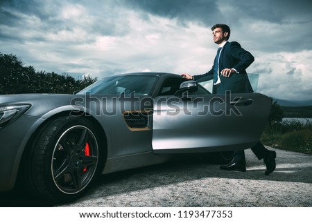 Business man in luxury car Royalty-Free Stock Photo #1193477353