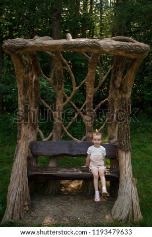little girl sitting on a bench
