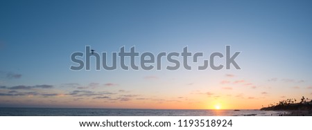 Panorama of the sun setting over Laguna Beach
