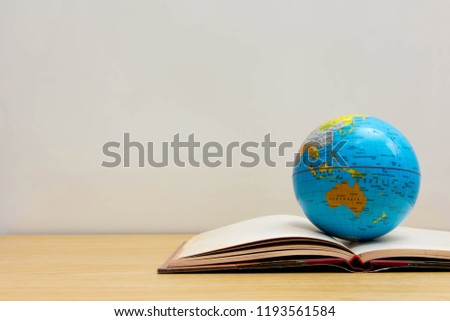 World globe on text book.
Graduate study abroad programs. 
International education school Concept. 
Distance learning online education. 
Stay home safe lives of covid or Coronavirus disease stop.