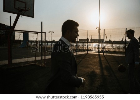 men in suits play basketball