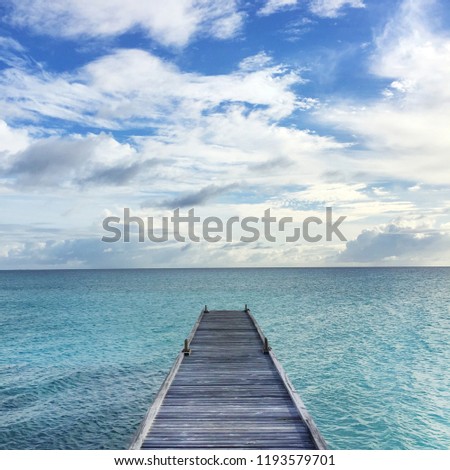 Wooden bridge Extends into the blue sea