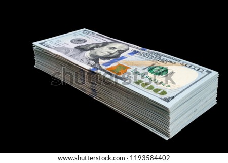 Stack of one hundred dollar bills isolated on black background. Stack of cash money in hundred dollar banknotes. Heap of hundred dollar bills background. Concept of financial success.
