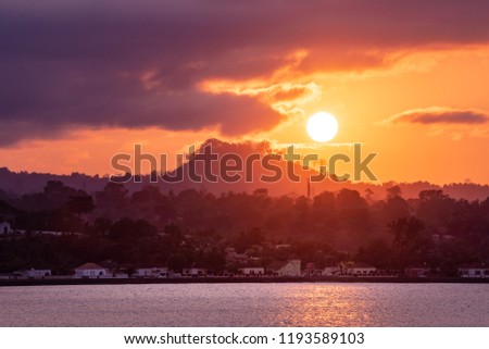 Sunset over Sao Tome Nature landscape of Sâo Tomé and Principe. Mountains like Pico Cão Grande. Travel to Sao Tome and Principe. Beautiful paradise island in Gulf of Guinea. Former colony of Portugal. Royalty-Free Stock Photo #1193589103