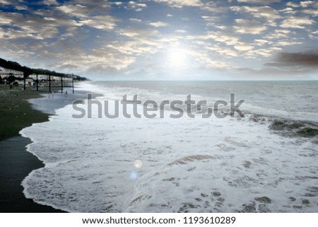 beautiful beach and waves of the sea coastline in the evening sunlight