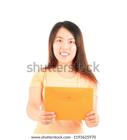 Happy young asian woman holding an orange envelope against a white background