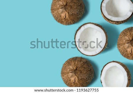 Top view of coconut isolated on blue background Summer concept. Flat lay. Pattern.