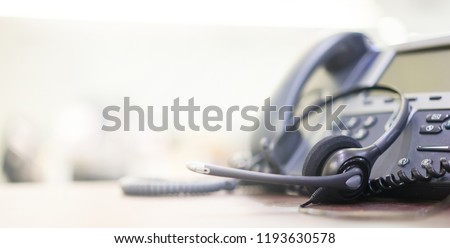 close up soft focus on telephone devices with copy space background at office desk in operation room for customer service support (call center) concept Royalty-Free Stock Photo #1193630578