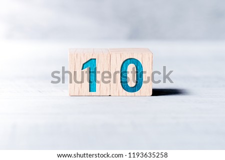 Number 10 Formed By Wooden Blocks On A White Table Royalty-Free Stock Photo #1193635258