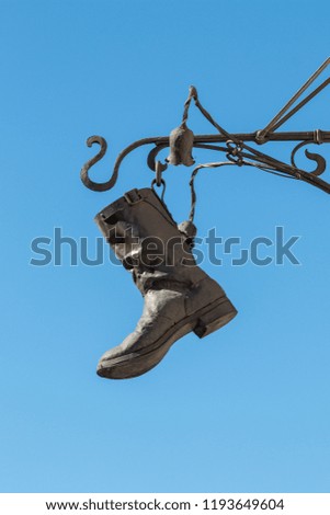 old shoe made of metal; advertising sign