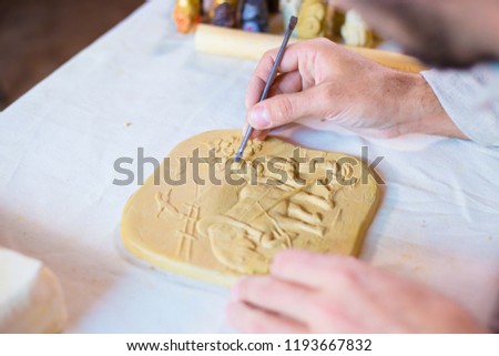 Professional male potter making clay stamp picture. Handwork, crafting and traditional arts concept
