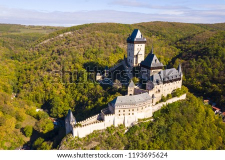 Aerial view of Karlstejn castle. Castle was founded by Holy Roman Emperor and king of Bohemia Charles IV in 14th century. Beautiful gothic castle Karlstejn in the Czech Republic from drone view.