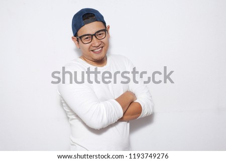 Photo image portrait of funny young attractive cute Asian man smiling happily, with arms crossed