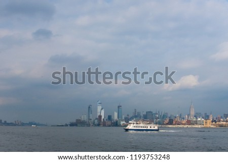 Skyline of Uptown Manhanttan with Ferry Travelling acros the Hudson River