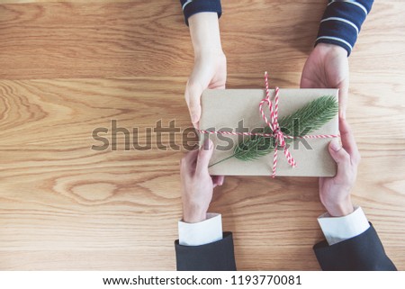 Gives a gift Christmas presents laid on a wooden table background. Xmas concept.