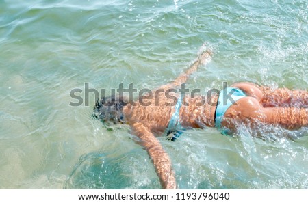 Girl is swimming. Young woman swimming underwater in sea