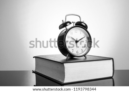 Clock and book with black and white view