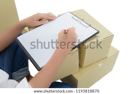 courier making notes in delivery receipt among parcels on boxes. isolated on white background with clipping path