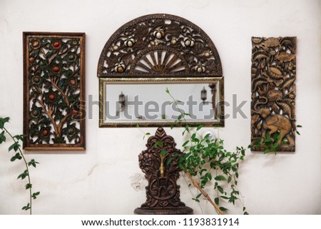 Wooden carved picture and fountain. Village houses for accommodation