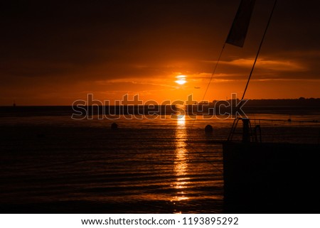 Sailing yachts on the pier in the rays of the setting sun