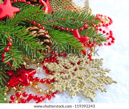 Christmas decorations of bauble are with the branches of fir on snow