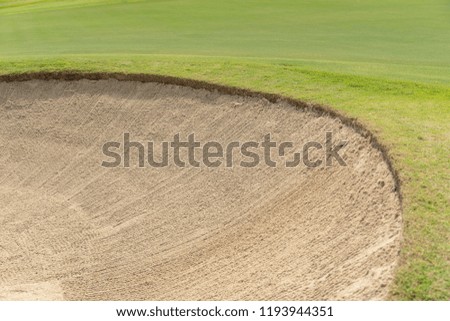 Beautiful Bunkers sand and green grass in golf court.