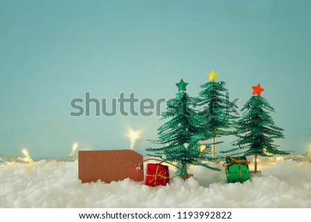 Image of paper christmas trees over white snow
