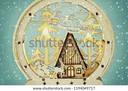 Image of magical christmas scene of wooden pine forest, hut and santa claus over sleigh with deers