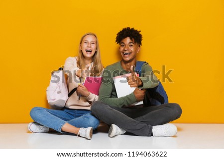 Photo of smiling students man and woman 16-18 using holding exer