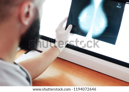 the doctor looks at a picture or mammogram-the result of an x-ray examination of the mammary glands for the prevention of breast cancer